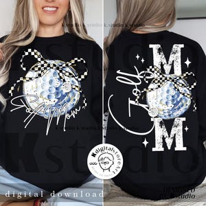 May include: Black sweatshirt featuring a golf ball design with a checkered bow and the words "Golf Mom" in white script. The back of the sweatshirt displays "Golf Mom" and the letter "M".