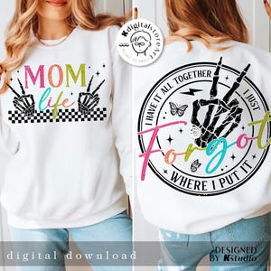 May include: White sweatshirt with a black and white checkered design and the text "MOM life" in rainbow colors. The back of the sweatshirt has a black and white circle with the text "I have it all together I just forgot where I put it" in rainbow colors.