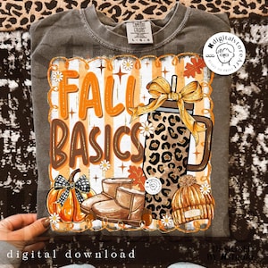 May include: A grey Comfort Colors t-shirt featuring a fall-themed design. The graphic includes the words "FALL BASICS", a leopard print mason jar, a pumpkin, boots, and a knit hat. The words "digital download" are at the bottom of the image.