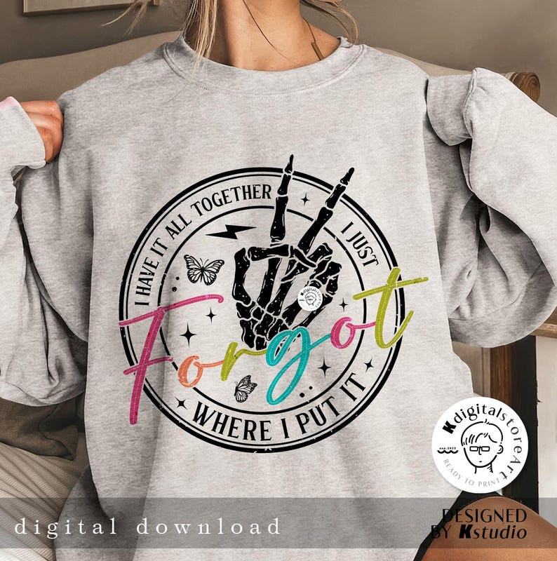 May include: A gray sweatshirt with a black and white graphic print of a skeleton hand making a peace sign. The graphic is surrounded by a black circle with the text "I have it all together I just forgot where I put it".
