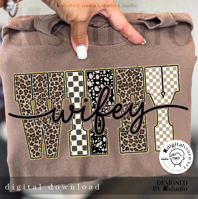 May include: A brown sweatshirt featuring the word "wifey" in a decorative font. The letters are patterned with leopard print, checkered, and polka dots, outlined in gold. The words "digital download" are printed at the bottom of the image.