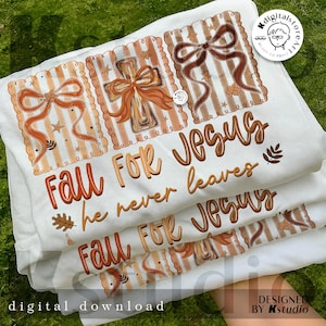 May include: White t-shirts with a fall-themed design. The design includes bows, a cross, and the text "Fall For Jesus, he never leaves." The shirts are stacked, with the design visible on the top shirt.
