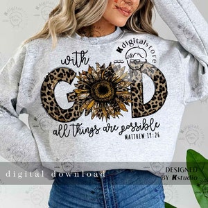 May include: A gray sweatshirt with a leopard print design that spells out "GOD" with a sunflower in the center. The text "with" is above the design and the text "all things are possible Matthew 19:26" is below the design.