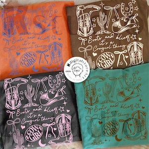 May include: Four t-shirts in orange, brown, charcoal, and teal, each featuring a Western-themed design. The design includes cowboy boots, a cowboy hat, a horseshoe, a cactus, and the text "Boots and bling, it's a Cowgirl thing."