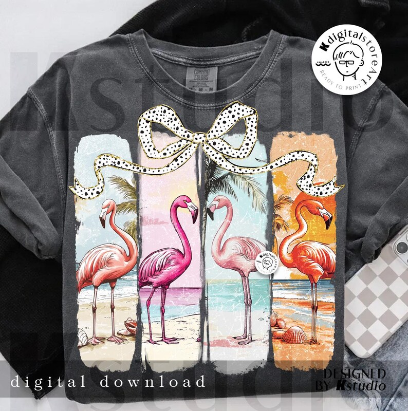 May include: Dark gray t-shirt featuring a colorful illustration of four flamingos on a beach, each in a different shade of pink and orange. A dotted bow is above the flamingos. Text at the bottom reads "digital download".