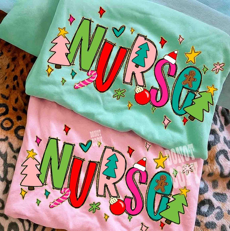 May include: Two Christmas-themed t-shirts, one mint green and one pink, with the word "NURSE" in large, colorful letters. The design includes Christmas trees, ornaments, candy canes, and a gingerbread man. The shirts are folded.