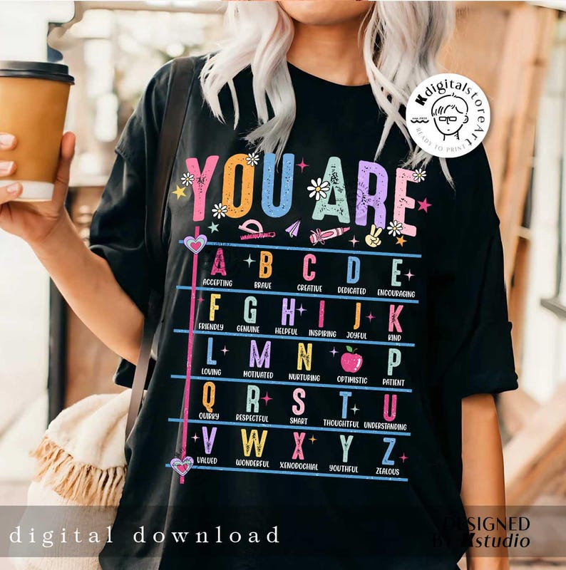 May include: Black t-shirt with a colorful graphic that says "You Are" and lists positive adjectives for each letter of the alphabet.