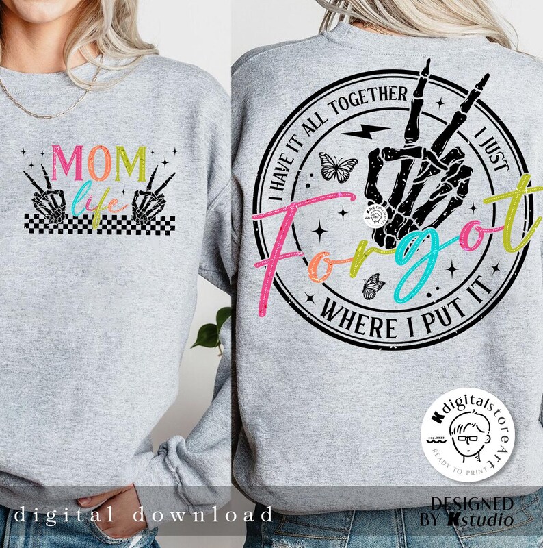 May include: A gray sweatshirt with two designs. The front design says "MOM life" with a checkered pattern and two skeleton hands with peace signs. The back design is a circle with the text "I have it all together I just forgot where I put it" with a skeleton hand with a peace sign, a butterfly, and lightning bolt.