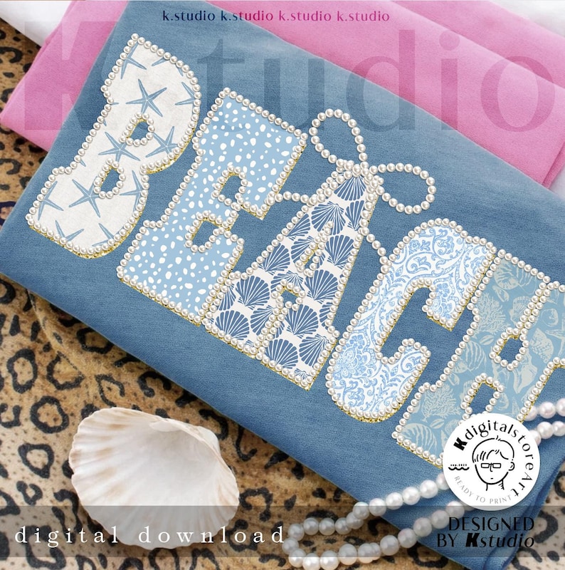 May include: A blue cushion featuring the word "BEACH" in large, decorated letters. The letters are embellished with seashells, starfish, and pearl-like beads. The cushion rests on a leopard print surface with a seashell and a string of pearls.