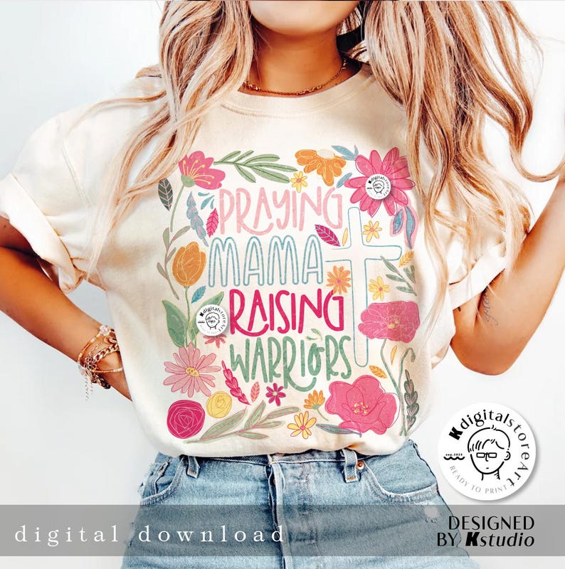 May include: A white t-shirt with a floral design and the text "Praying Mama Raising Warriors".