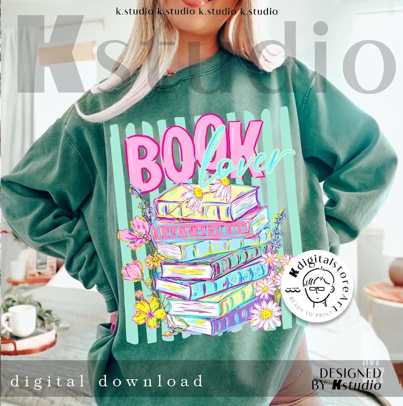May include: Green sweatshirt with the words "BOOK Lover" in pink and blue, above a stack of colorful books with floral accents. The design includes the text "digital download" and "DESIGNED BY Kstudio".