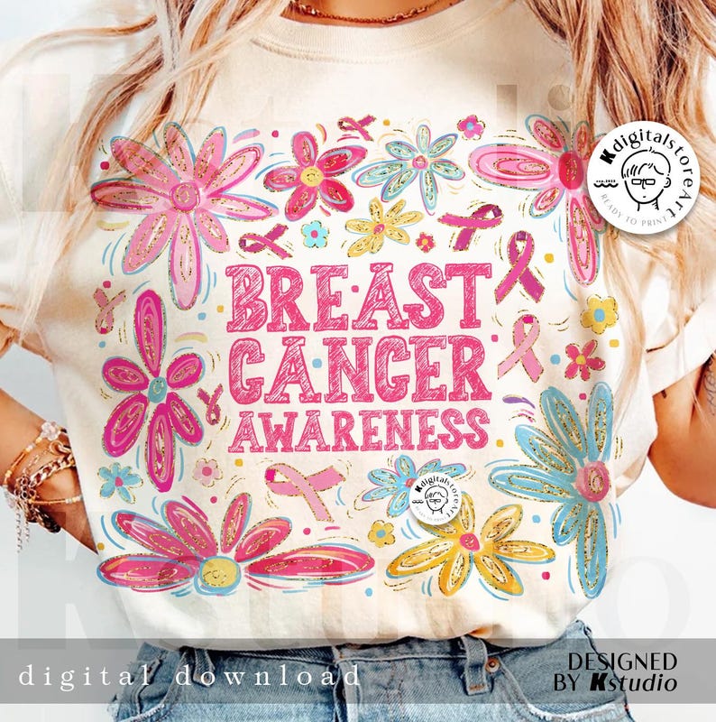 May include: Cream-colored t-shirt with the words "BREAST CANCER AWARENESS" in pink, surrounded by pink, blue, and yellow floral designs and pink ribbons. The words "digital download" are at the bottom.