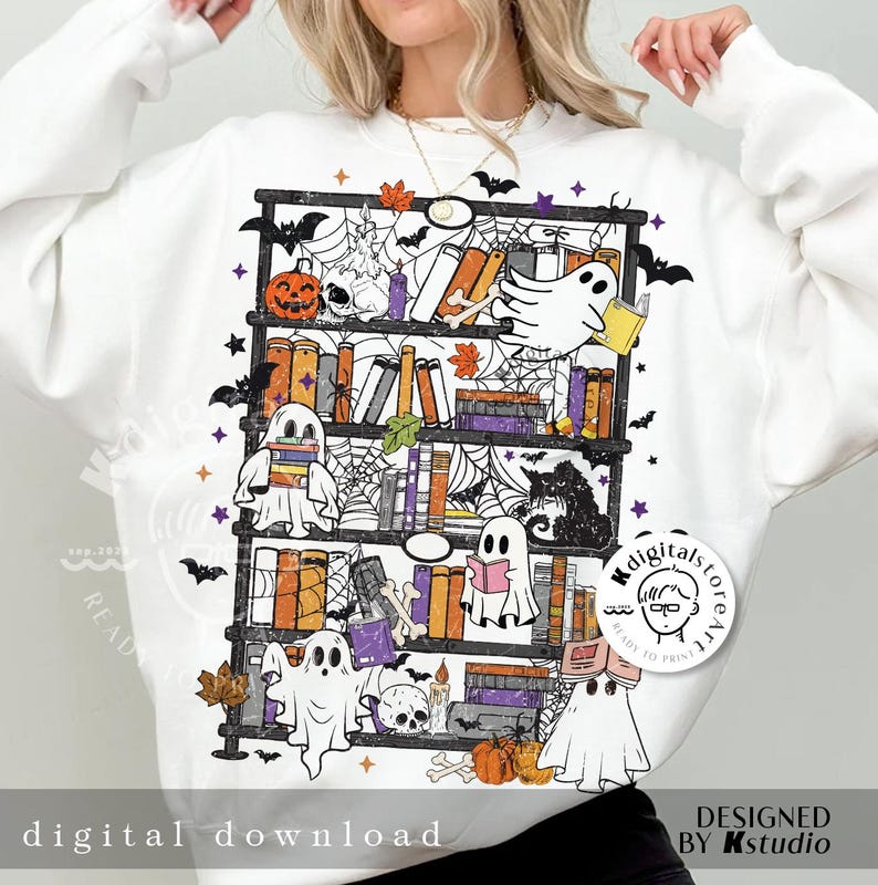 May include: White sweatshirt featuring a Halloween-themed bookshelf design. The graphic includes ghosts, pumpkins, books, bats, and spiderwebs. The words "digital download" are printed at the bottom of the sweatshirt.