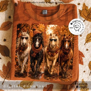 May include: A burnt orange sweatshirt featuring a graphic of four horses wearing sunglasses, scarves, and fall foliage. The horses are set against a backdrop of autumn trees. The words "digital download" and "designed by Kstudio" are also visible.