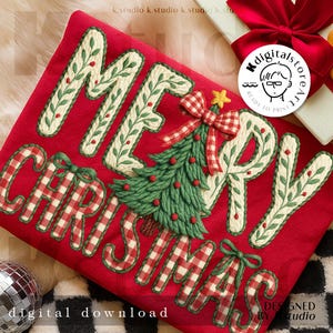 May include: A festive red Christmas design featuring the words "MERRY CHRISTMAS". The letters are cream-coloured with green leaf detailing. A green Christmas tree with a red and white checked bow is central. The words "digital download" are at the bottom of the design.