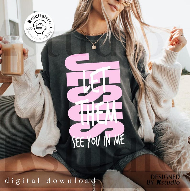 May include: Dark gray t-shirt with the text "JESUS LET THEM SEE YOU IN ME" in pink. The shirt is a digital download. The design is by Kstudio.