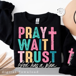 May include: Black sweatshirt with a colorful graphic that says "Pray Wait Trust God has a plan" with a cross on the right side of the text.