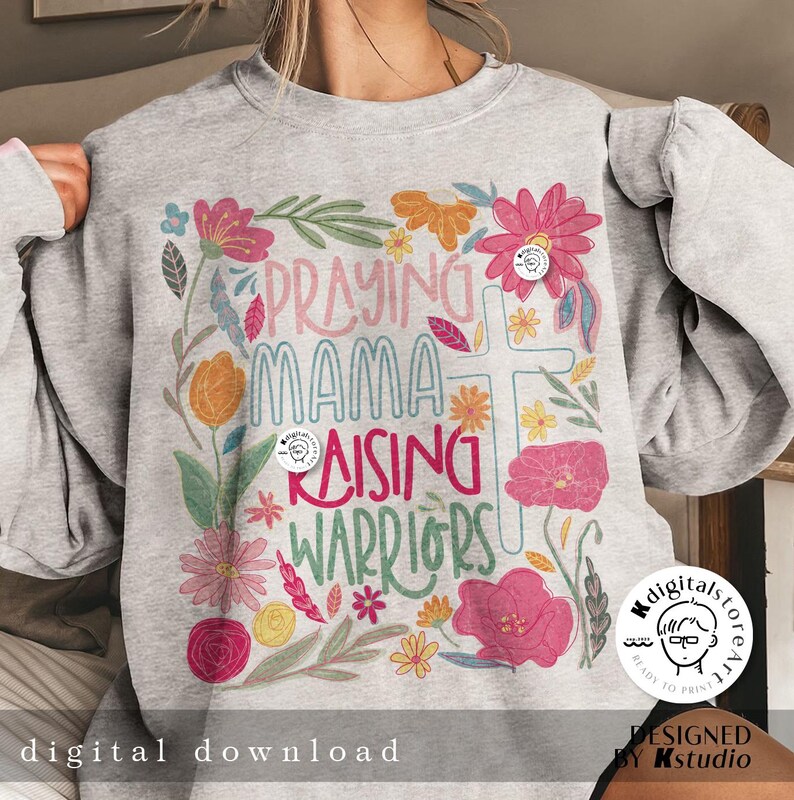 May include: A gray sweatshirt with a floral design and the text "Praying Mama Raising Warriors".