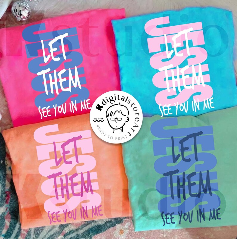 May include: Four colorful t-shirts, each displaying the text "LET THEM SEE YOU IN ME." The shirts are in pink, teal, orange, and green, with the text in contrasting colors. A small logo is visible in the center.
