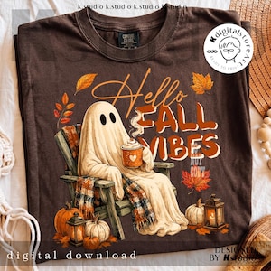May include: Brown t-shirt with a graphic of a ghost in a chair, holding a coffee cup, with the text "Hello Fall Vibes." Pumpkins, leaves, and a lantern are also featured in the design. The words "digital download" are at the bottom.