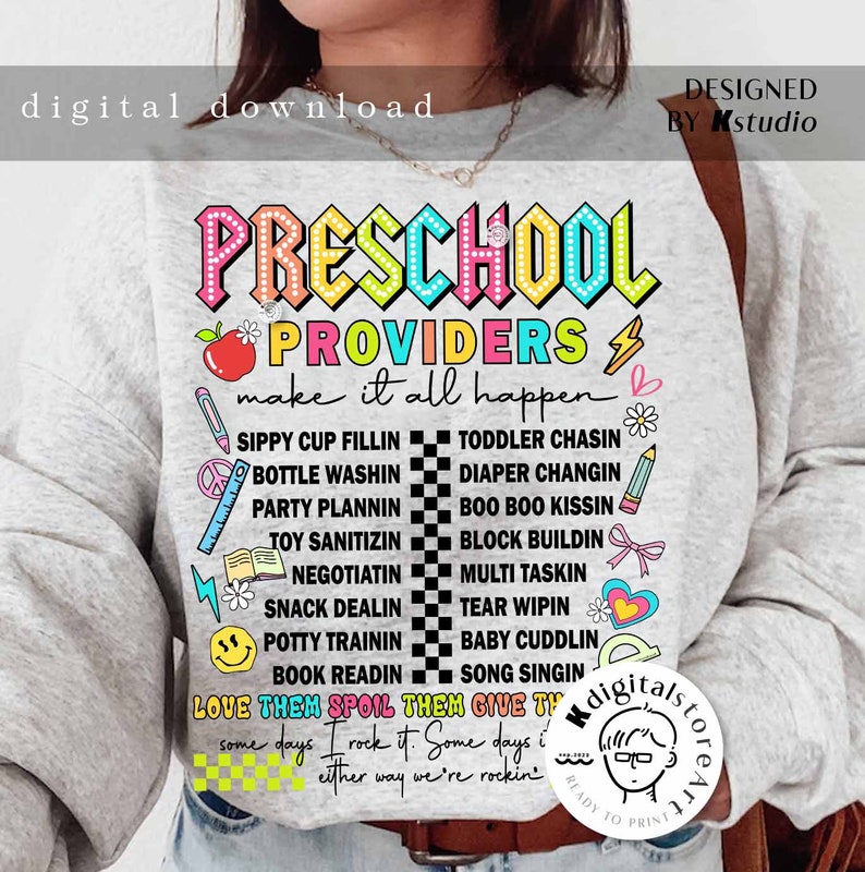May include: A gray sweatshirt with the text "PRESCHOOL PROVIDERS make it all happen" in rainbow colors. The text is surrounded by various colorful icons and illustrations related to preschool activities, such as sippy cups, diapers, and books. The text "LOVE THEM SPOIL THEM GIVE THEM" is also included in the design.