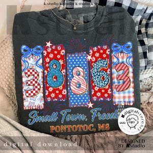 May include: Dark grey sweatshirt with a patriotic design featuring the numbers 3863 in red, white, and blue patterns. The text "Small Town, Freedom, Pontotoc, MS" is printed below the numbers. A digital download graphic.