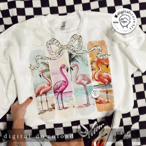 May include: White sweatshirt featuring a colorful flamingo design. The design includes four flamingos on a beach with a bow. The words "digital download" are printed at the bottom of the sweatshirt.