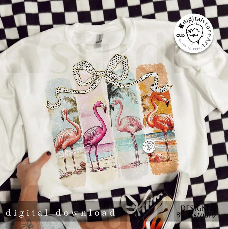 May include: White sweatshirt featuring a colorful flamingo design. The design includes four flamingos on a beach with a bow. The words "digital download" are printed at the bottom of the sweatshirt.