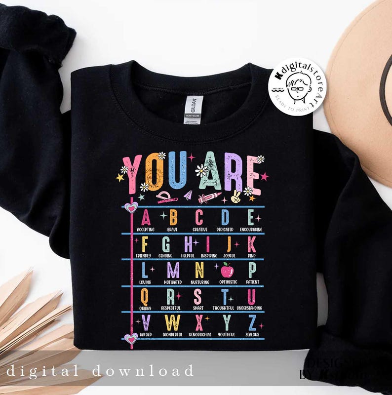May include: Black sweatshirt with a colorful graphic that says "You Are" and lists positive adjectives for each letter of the alphabet.