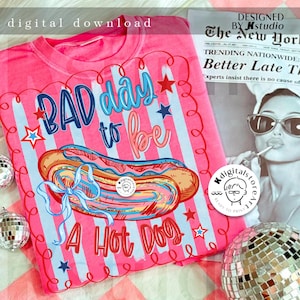 May include: Pink t-shirt with a graphic of a hot dog and the phrase "Bad Day to be a Hot Dog." The design includes blue and red stars and stripes. The words "digital download" are at the top.