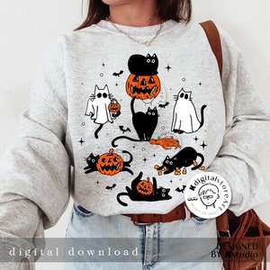 Puede incluir: Una sudadera gris claro con un dise&ntilde;o de Halloween. El dise&ntilde;o incluye gatos negros, calabazas, murci&eacute;lagos y un fantasma. El texto "digital download" est&aacute; impreso en la parte inferior. El dise&ntilde;o est&aacute; listo para imprimir.