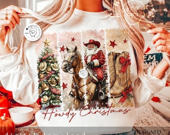 May include: A white sweatshirt with a Christmas design featuring a cowboy hat, a horse, a cowboy boot, and the text "Howdy Christmas".