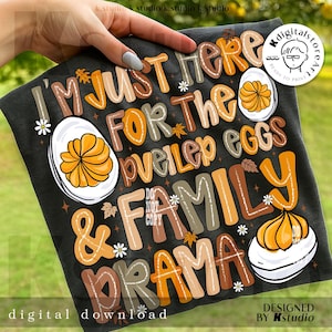 May include: Black t-shirt with the text "I'M JUST HERE FOR THE deviled eggs & FAMILY DRAMA" in various colors. The design includes illustrations of deviled eggs, daisies, and autumn leaves. "Digital download" is printed at the bottom.