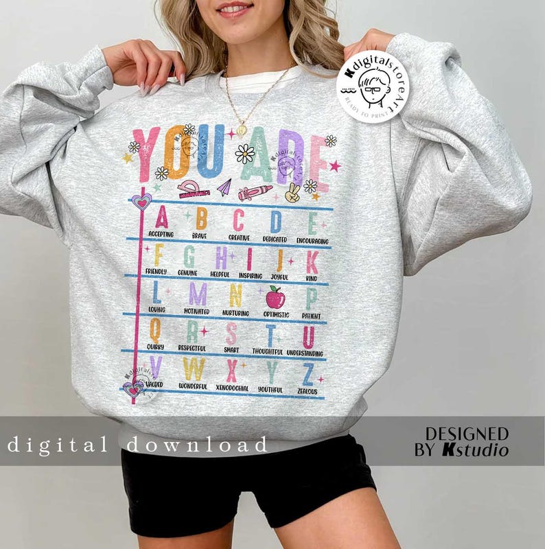 May include: A gray sweatshirt with the text "YOU ARE" in rainbow colors and a colorful alphabet chart with positive adjectives for each letter. The text "digital download" is at the bottom of the image.