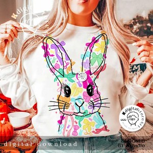 May include: A white sweatshirt with a colorful graphic of a bunny rabbit made of bows. The graphic is centered on the front of the sweatshirt. The text "digital download" is at the bottom of the image.