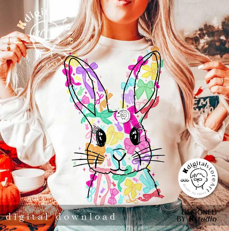 May include: A white sweatshirt with a colorful graphic of a bunny rabbit made of bows. The graphic is centered on the front of the sweatshirt. The text "digital download" is at the bottom of the image.