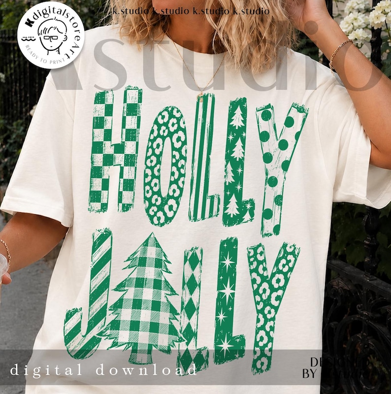 May include: An off-white short-sleeve t-shirt featuring the green text HOLLY JOLLY. The letters are filled with various patterns including green and white checkers, leopard print, stripes, Christmas trees, polka dots, and stars.