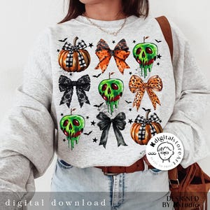 May include: A light gray sweatshirt featuring a Halloween-themed design. The design includes illustrations of pumpkins, bows, and green apples with dripping green goo. The words "digital download" are printed at the bottom.