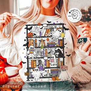 May include: White sweatshirt featuring a Halloween-themed bookshelf design. The design includes ghosts, pumpkins, books, bats, and spiderwebs. The words "digital download" are printed at the bottom of the sweatshirt.