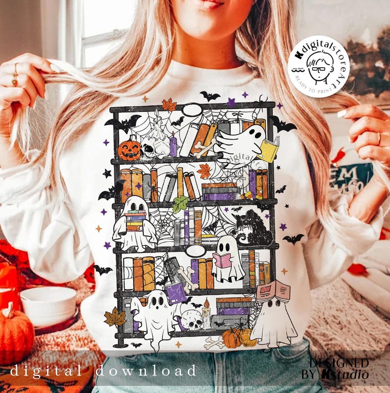 May include: White sweatshirt featuring a Halloween-themed bookshelf design. The design includes ghosts, pumpkins, books, bats, and spiderwebs. The words "digital download" are printed at the bottom of the sweatshirt.