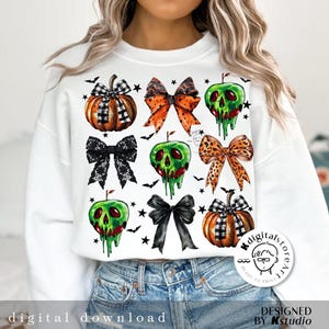 May include: White sweatshirt featuring Halloween-themed graphics. The design includes pumpkins, bows, and dripping green apples. The text "digital download" is at the bottom. The design is by Kstudio.