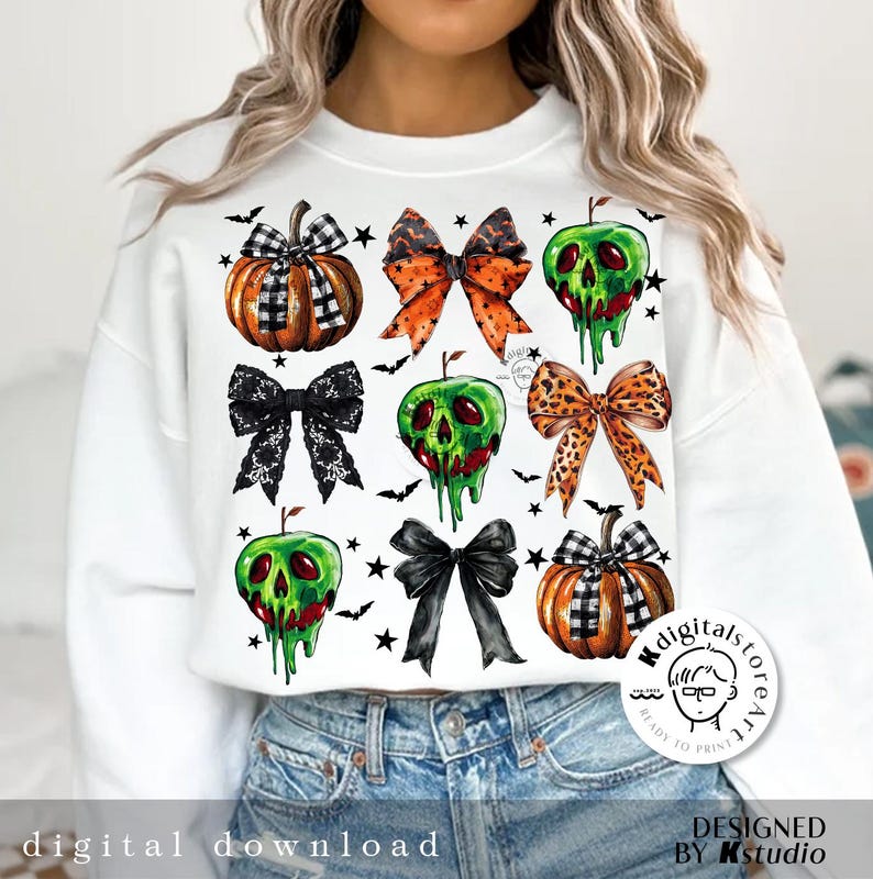 May include: White sweatshirt featuring Halloween-themed graphics. The design includes pumpkins, bows, and dripping green apples. The text "digital download" is at the bottom. The design is by Kstudio.