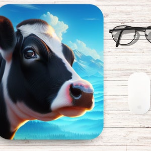 May include: Close-up of a black and white cow's face with a pink nose. The cow is looking to the right, and the background is a blue sky with white clouds and a mountain range.