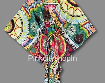 May include: A colorful, patterned kaftan with a V-neckline and a tie at the waist. The fabric features a variety of geometric and floral designs in shades of red, green, yellow, blue, and brown.