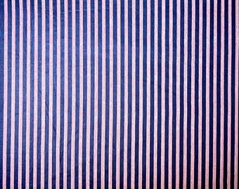 May include: A fabric with alternating blue and pink vertical stripes. The fabric has a subtle texture.