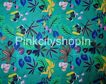May include: Teal fabric with a repeating pattern of stylized leaves and flowers in shades of green, blue, pink, yellow, and black.