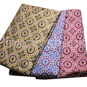 May include: Three fabric swatches with a repeating geometric pattern. The swatches are in shades of green, blue, and red.