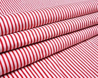 May include: Red and white striped fabric with a smooth texture. The fabric is folded in thirds, showing the stripes.