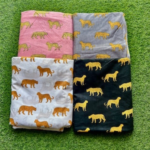 May include: Four fabric swatches with a leopard print pattern. The swatches are in pink, gray, white, and black.