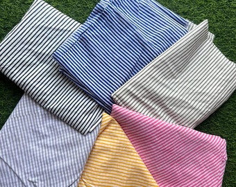 May include: Five different striped fabric swatches. The swatches are in various colors, including black and white, blue and white, gray and white, yellow and white, and pink and white.